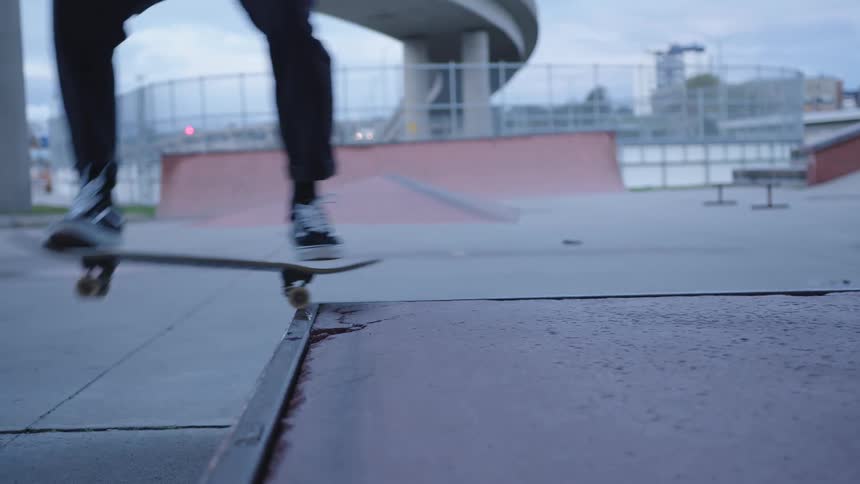 Person performing a skateboard trick at an outdoor skate park