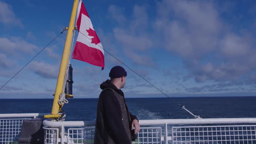 The man is riding on the ferry