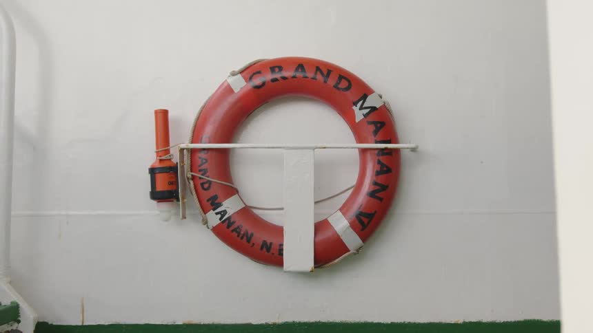 The life preserver hangs on the ship wall