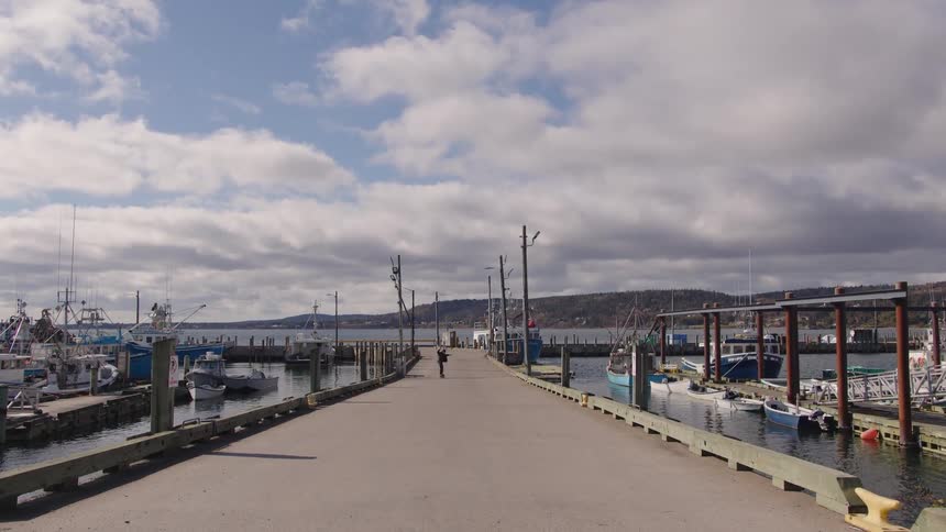 A man skateboards on a pier