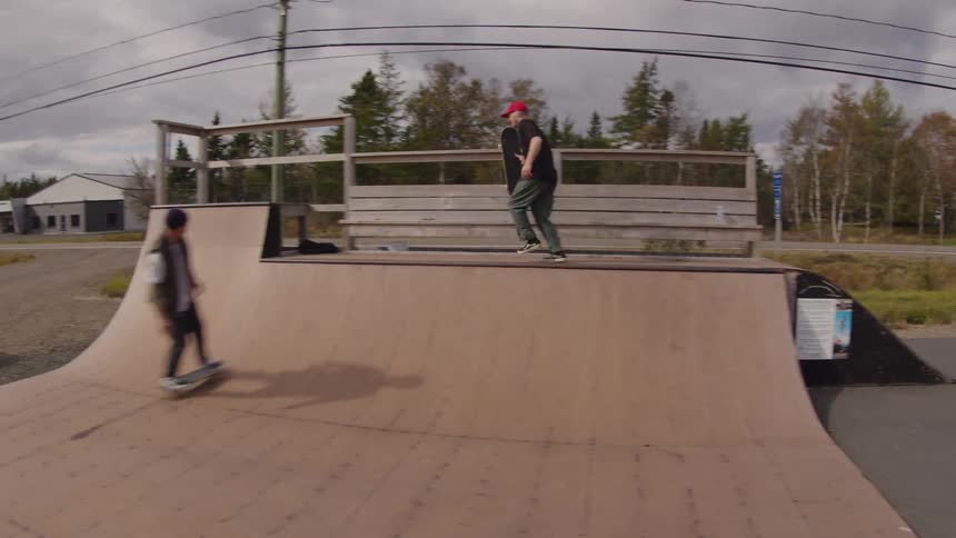 Two skateboarders practicing skate at a skate park