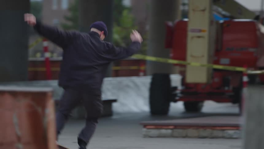 The man turns on the road with his skateboard