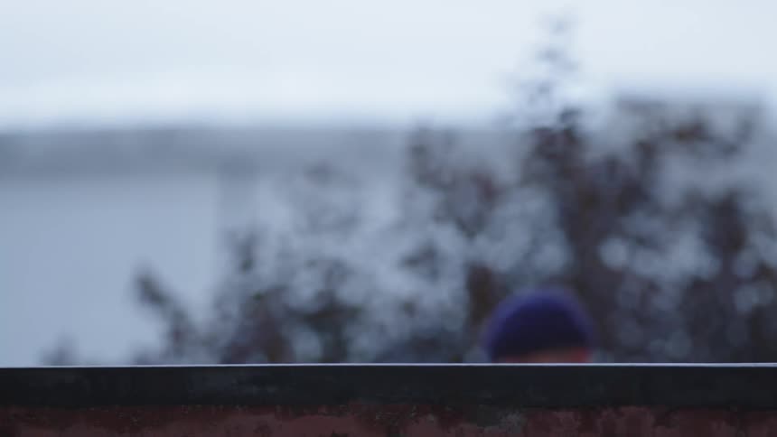 Skateboard grinds along a ledge in a compact shot