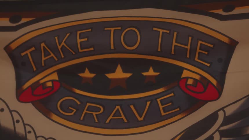 The colorful sign reads take to the grave