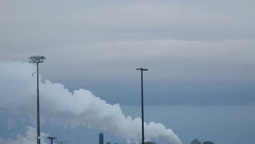 Steam flows under a cloudy sky