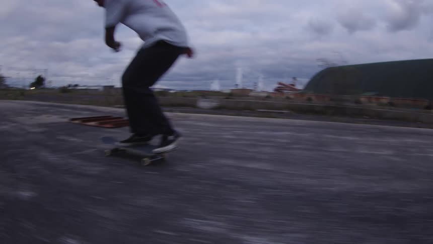 The teenager does a jump on his skateboard