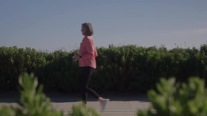 Woman walking outdoors on a sunny morning