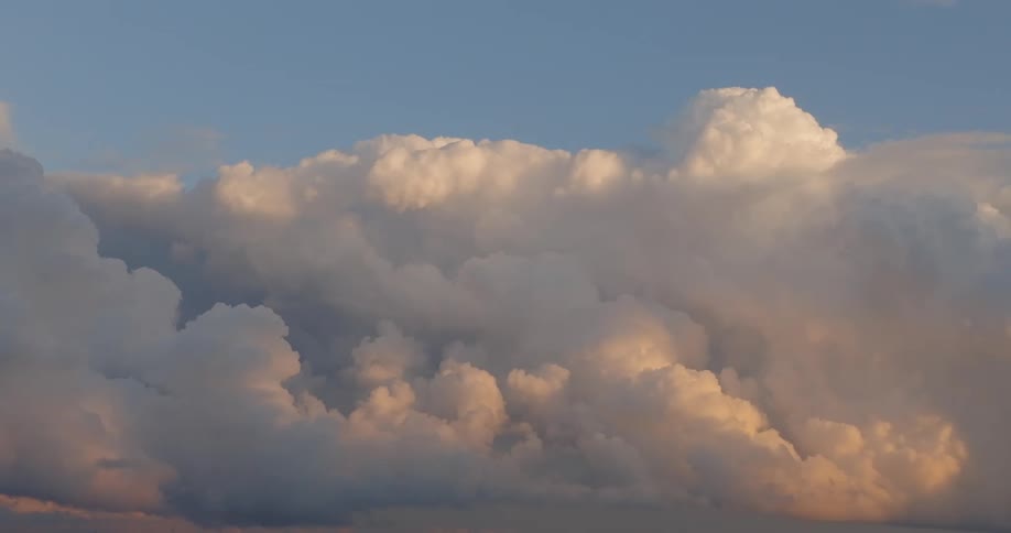 Dense cloud formations lit by the evening light