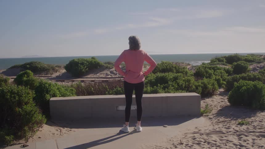 A woman stands outside viewing the view