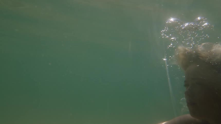 Woman swims in underwater