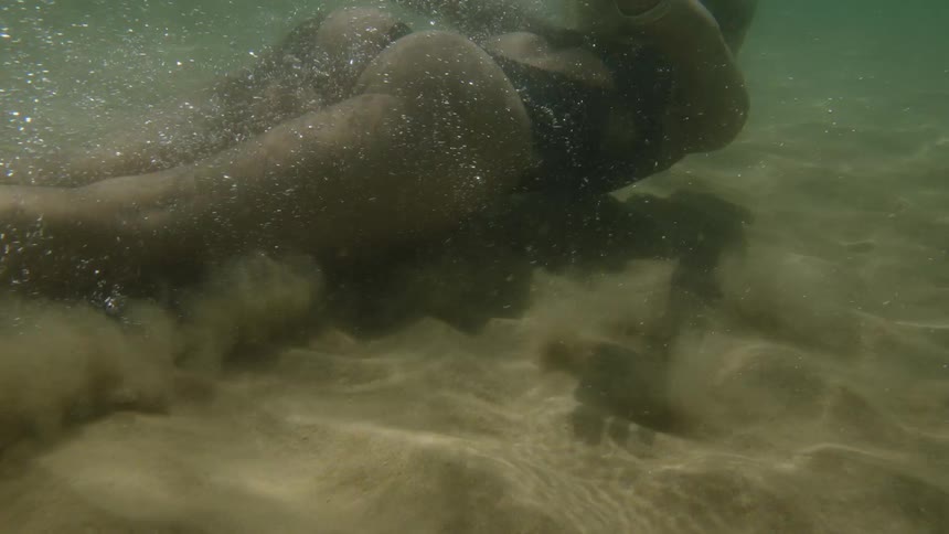 A woman dives into the ocean