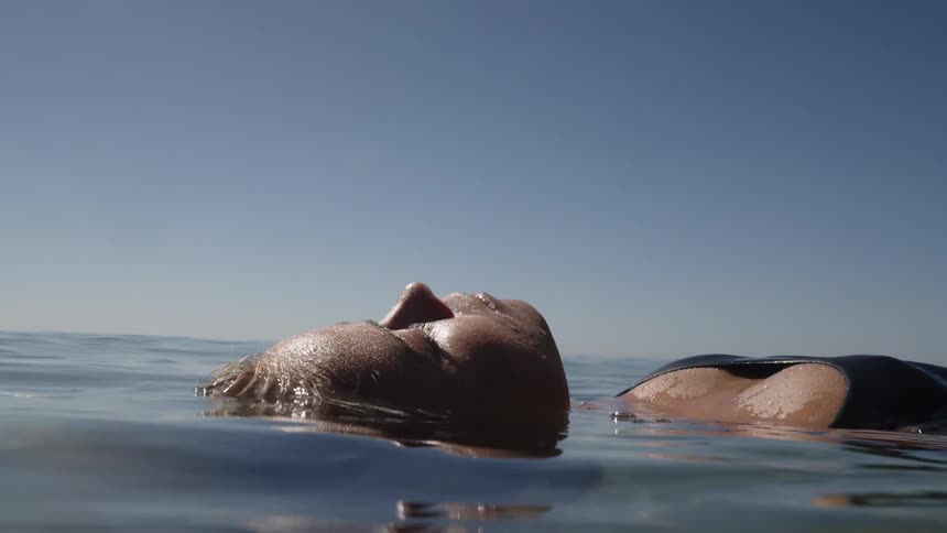 The woman floats in the water