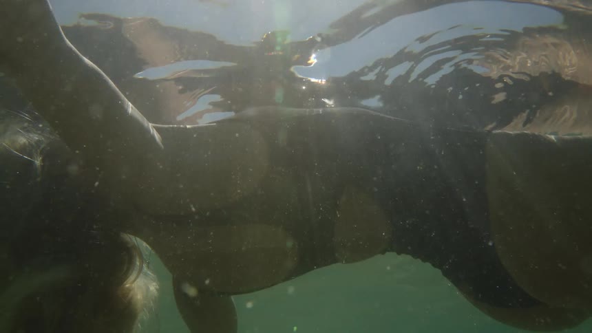 The video is an underwater shot that is dark and murky possibly showing a body or large object submerged in the waterthe low visibility and lack of clear detail create a sense of mystery and gloom in the scene