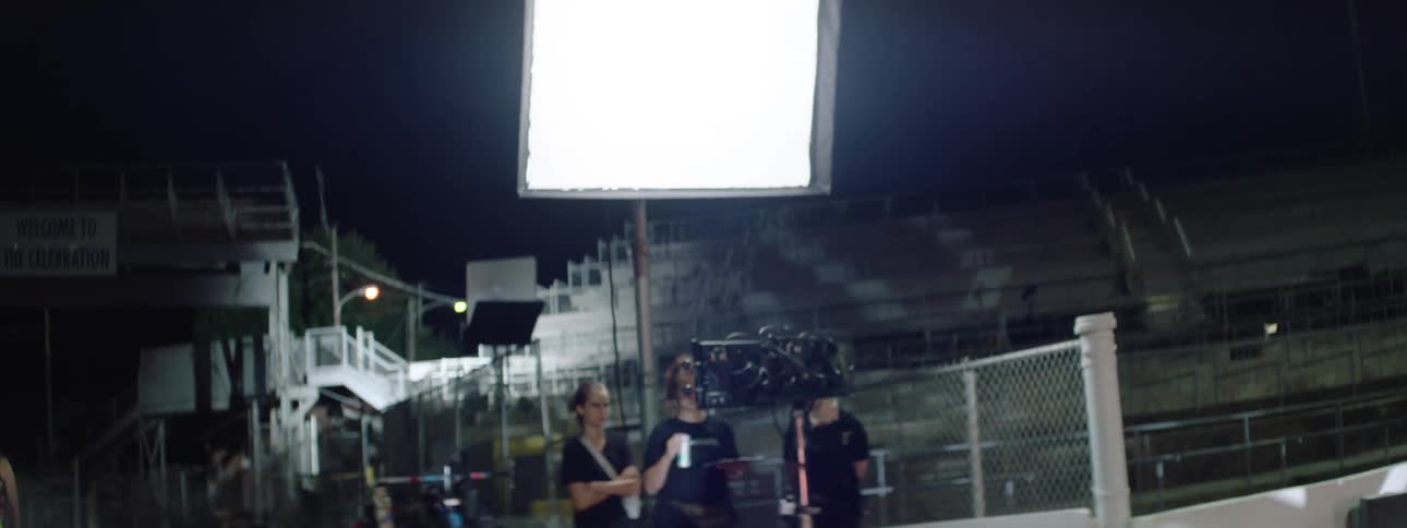 The band are recording a music video on the field
