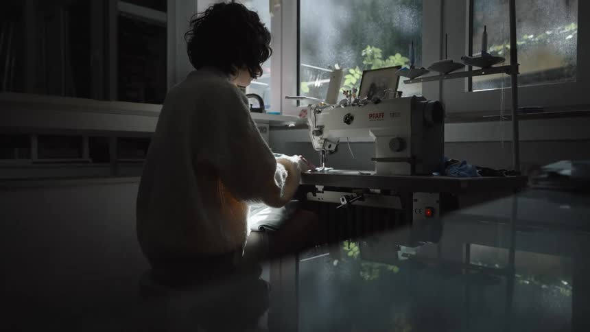 A woman sewing with a sewing machine