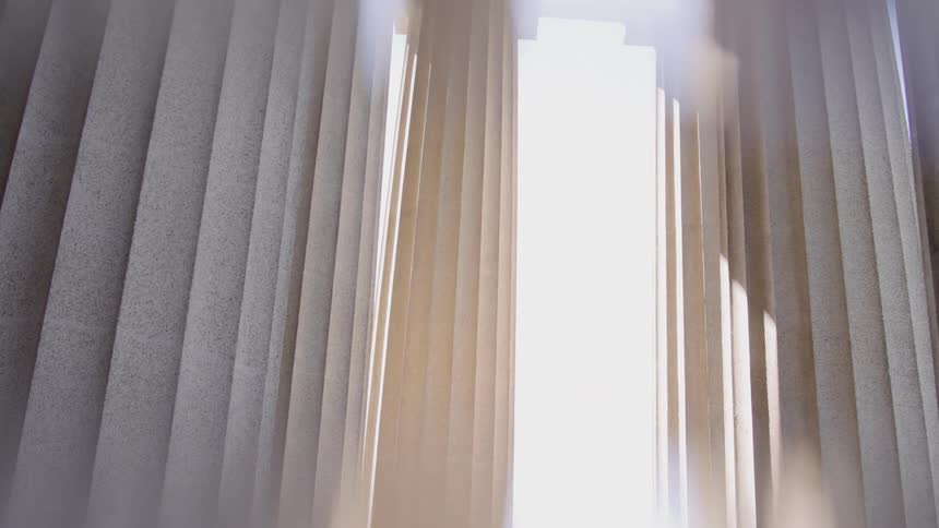 Light shining through tall vertical architectural columns