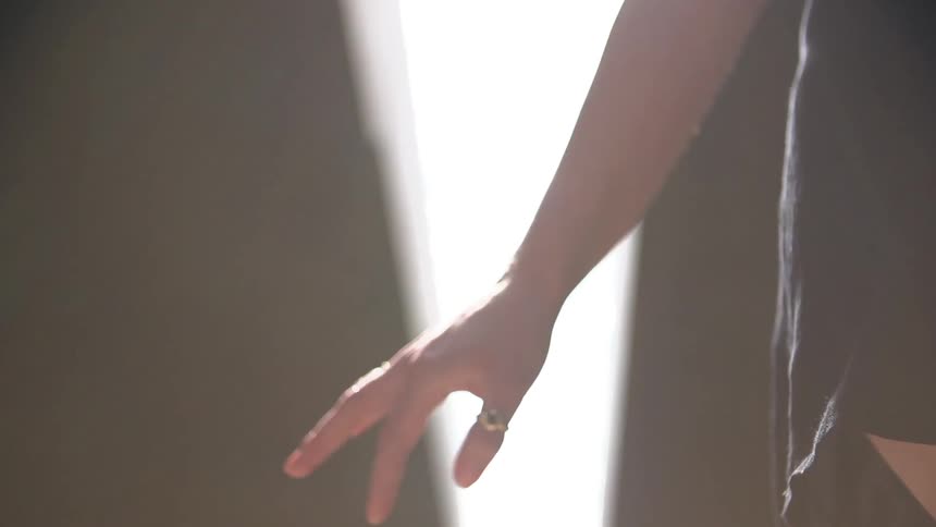 Woman has her hand stretched out beside her