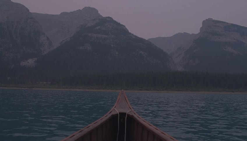 Mountains lie ahead of the canoe
