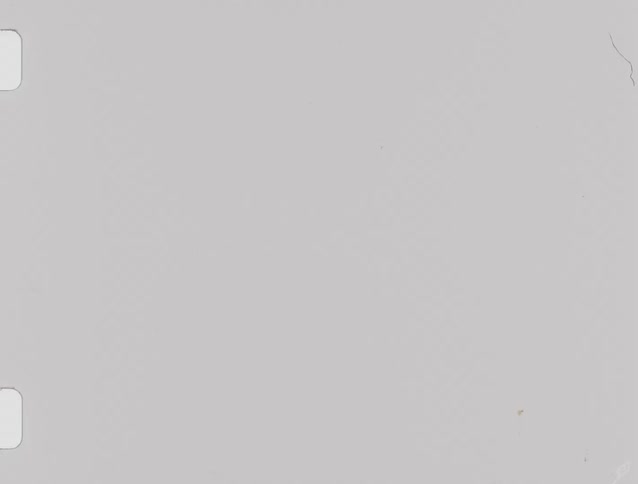 A bright view shows a white or light gray surface with dark rounded film frames visible on the left and right sides of the image