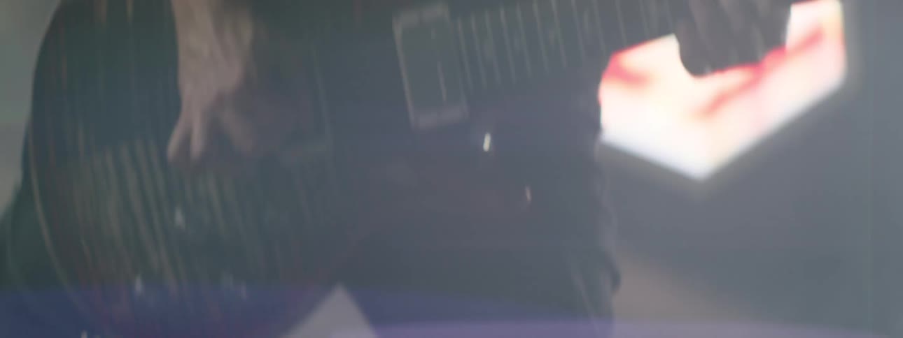 Close up of rock star jamming on guitar during a concert
