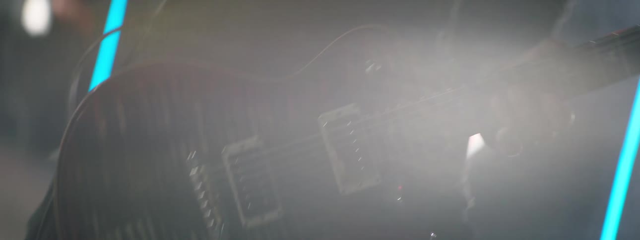 A man playing a guitar at a concert