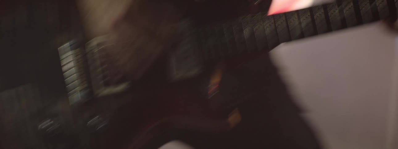 The video appears to be an abstract shot featuring shifting colors and light effects transitioning from a dark purple to a brownred hue with a streak of bright blue light its too abstract to describe in terms of people or objects