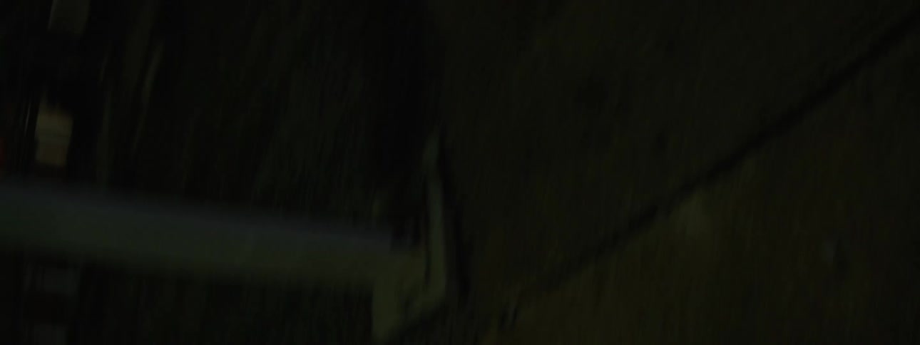 Detail of dark metallic surface reflecting a white light strip