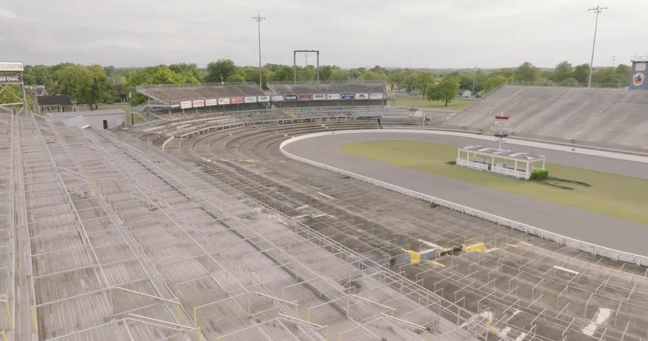 Empty metal bleachers of a racetrack seen from above on a cloudy day