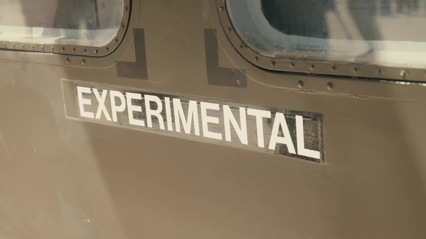 Experimental inscription on a metallic fuselage near aircraft windows