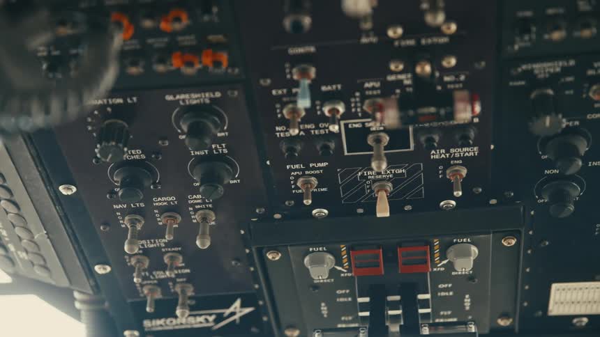 The video is a detailed closeup shot of an overhead control panel in an aircraft cockpit likely a sikorsky helicopter as indicated by the logo the panel is filled with various switches toggles lights and labels related to fuel light
