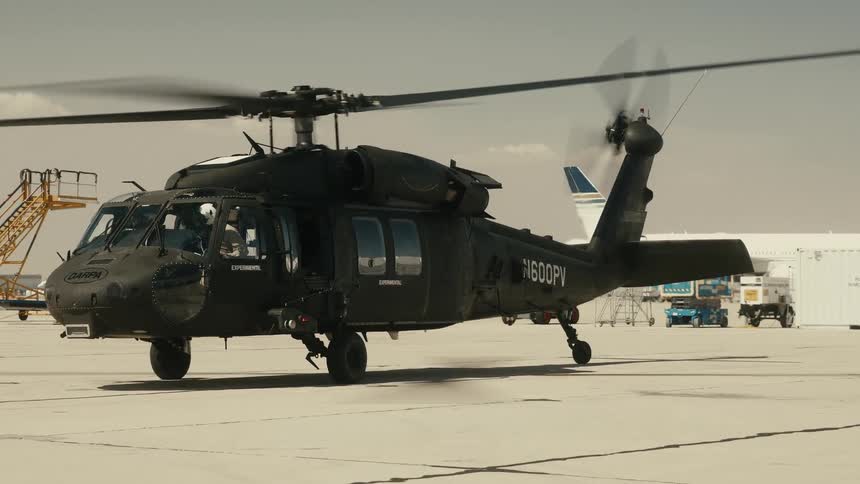 Black military helicopter on runway ready for takeoff