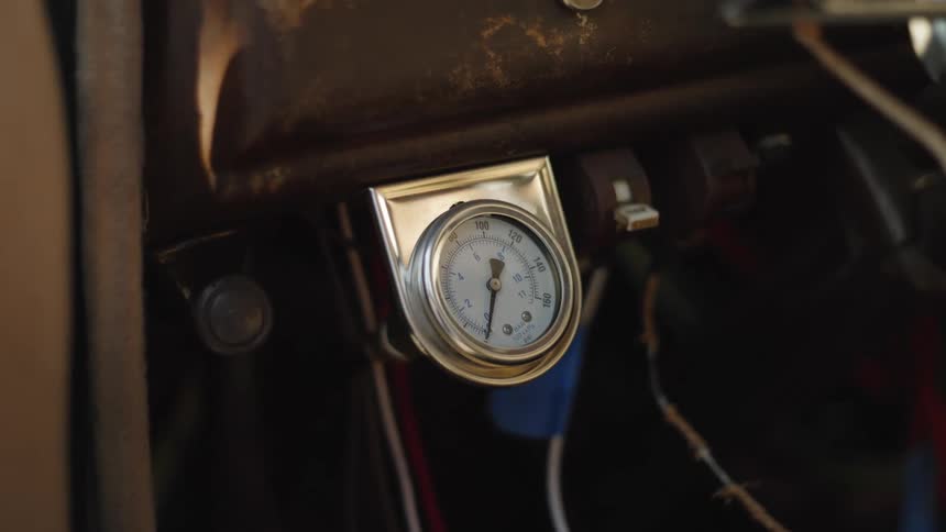 Vintage gauges are displayed on an aged dashboard interior