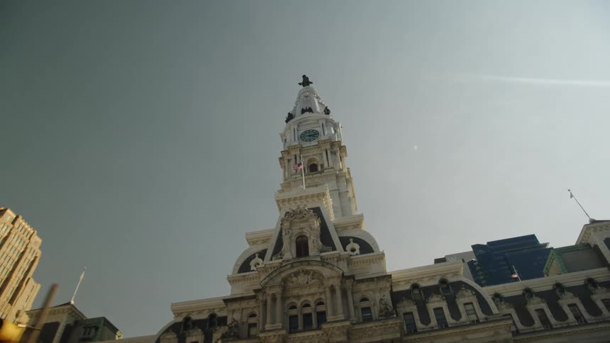 Philadelphia city halls central tower with william penn statue under clear sky in second empire architectural style