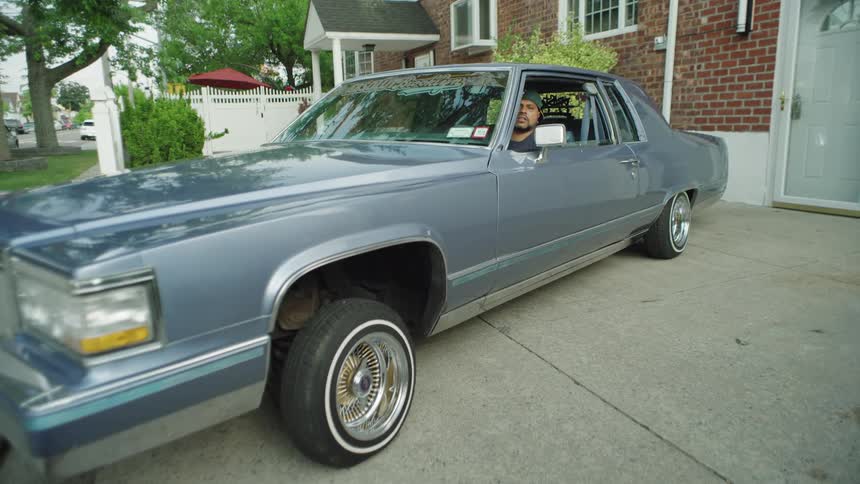 A man inside a car that is bouncing in a lowrider style