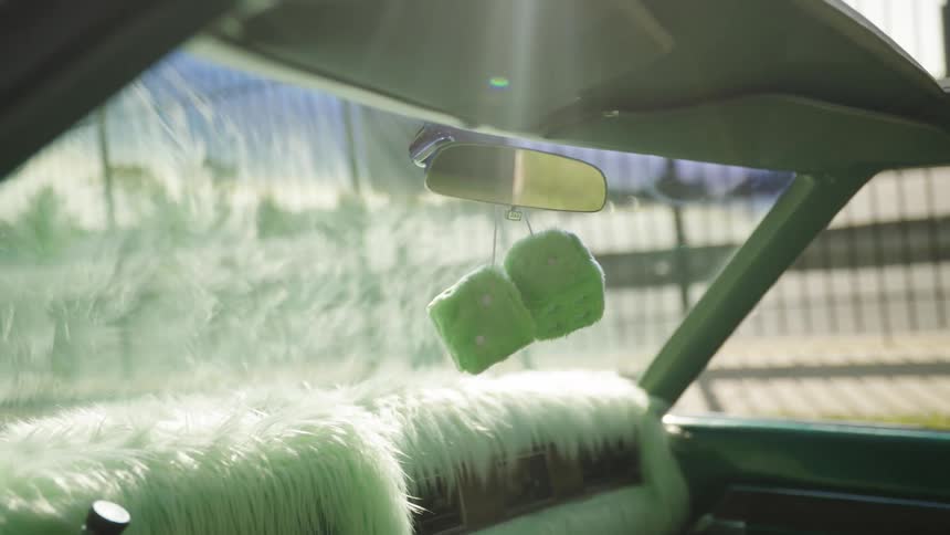 Pimp mobile with fuzzy dice and shag carpet on the dashboard