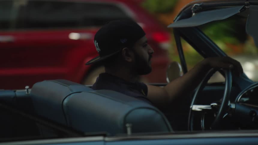 Man driving convertible car in daylight