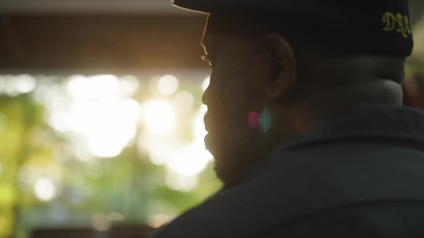 A man wearing a beret looking to the side
