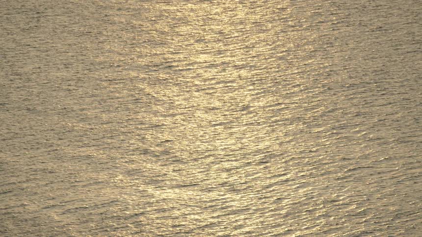 Aerial of a calm sea at sunset