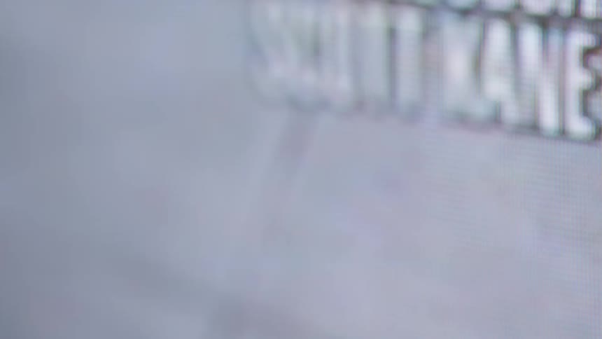 The video is an extreme closeup shot of a digital screen like a tv or computer monitor revealing the individual red green and blue rgb pixels the content displayed on the screen is blurry and abstract but appears to include some text o