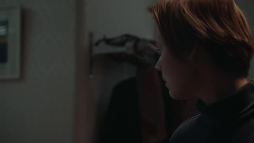 The woman turns and walks down the hall