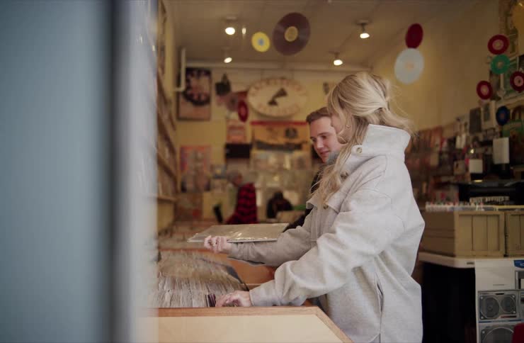 Man and woman browse through the records in a music store