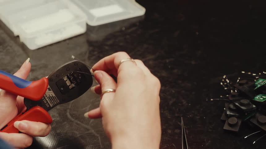 The person is using a tool on the computer chips