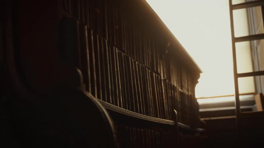 Close up of the cozy interior of a room with warm sunlight filtering over wooden furniture