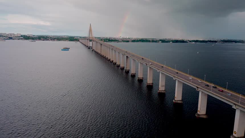 Cars drive over a bridge