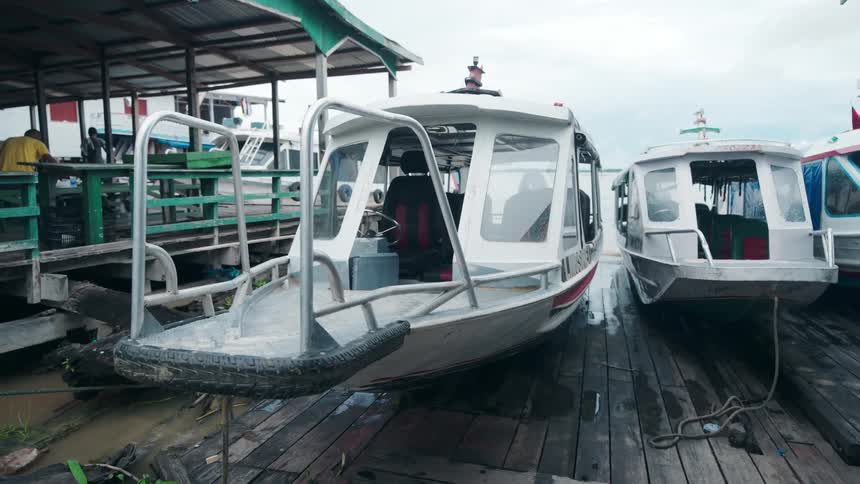 Boats have been pulled up onto a dock next to a structure