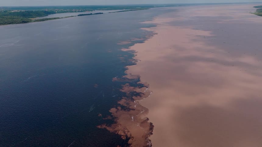 A sludge is in the water near a coastal area