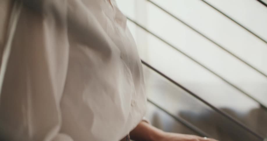 Closeup of a woman typing on a laptop indoors