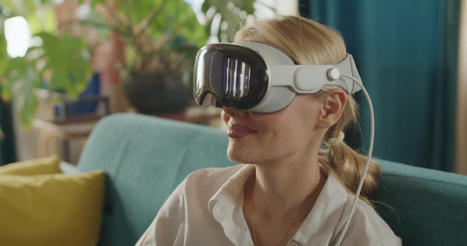Woman using a VR headset on a couch
