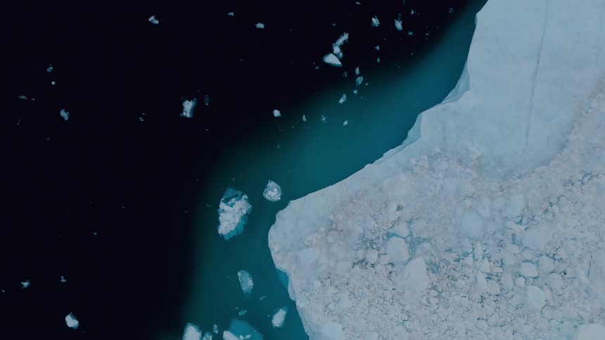 Aerial view of an iceberg and the arctic ocean