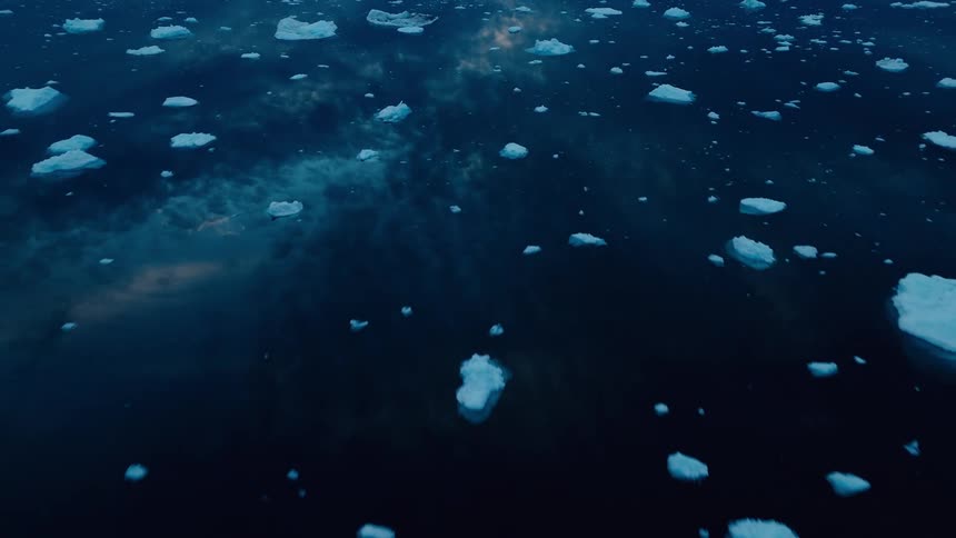 Pieces of icebergs floating in the arctic ocean at night